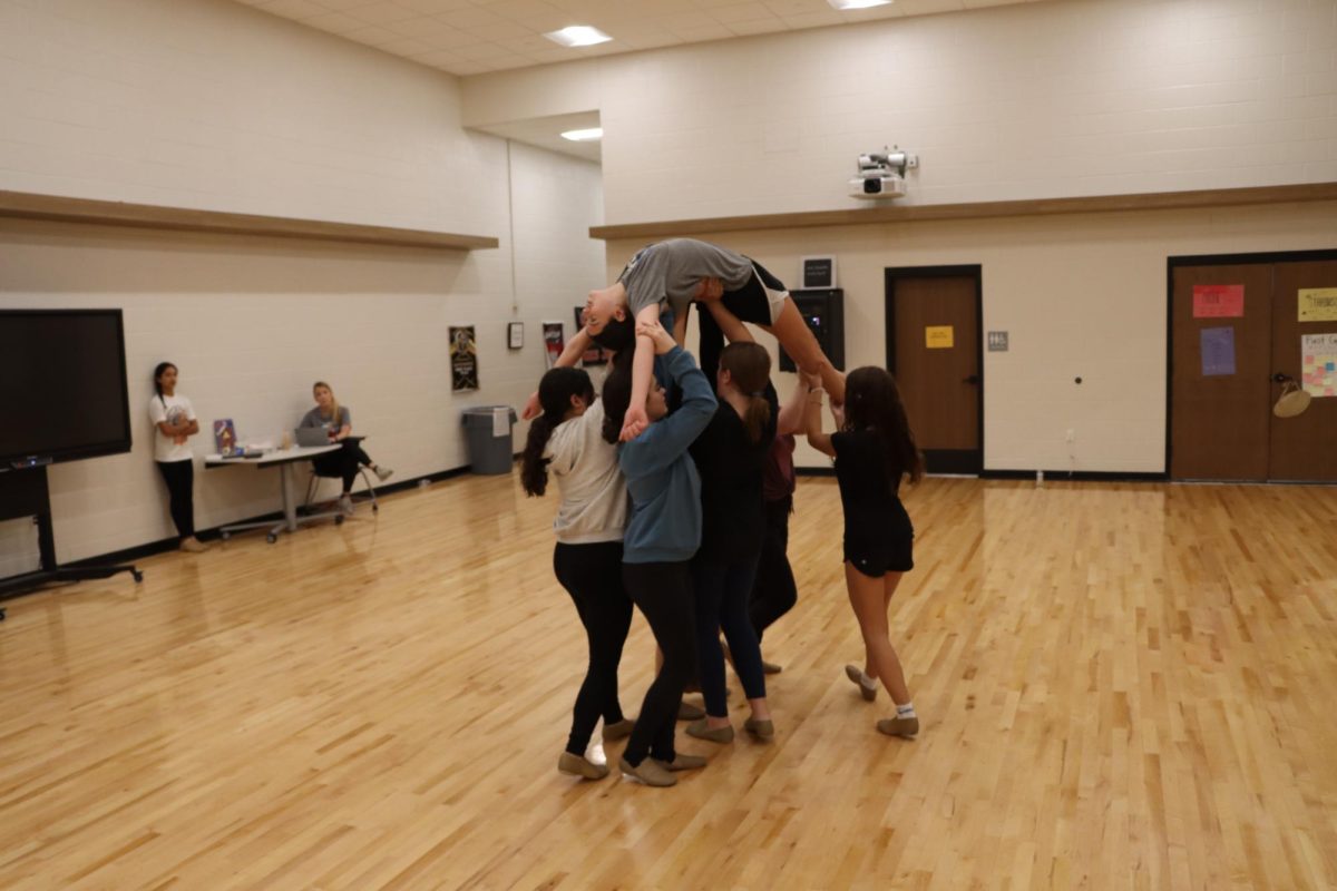 5, 6, 7, 8! Dancing for Coach Kathryn Reeves, 8th graders Ruby Wilson  and Destiny Deason lifts Selah Rabalais. During class students learned their routine for the fall show. Being lifted Is kinda scary, but also its also really fun, Said Rabalais.