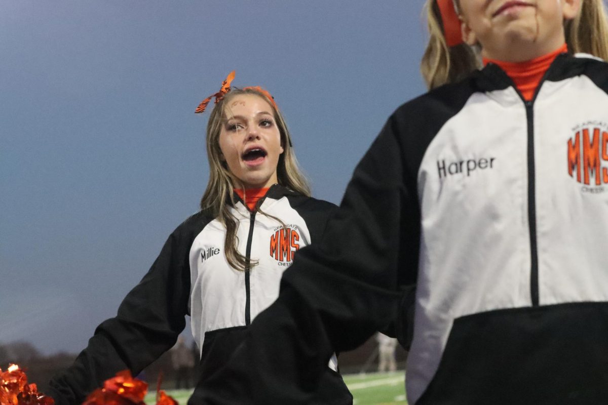 Spooky Season. Tuesday night Millie Coppinger cheers for the boys last football game. To make this night special the cheer girls did scary make-up looks to go with their cheer dance. It was fun, but it took away my time to trick or treat,  Coppinger said.