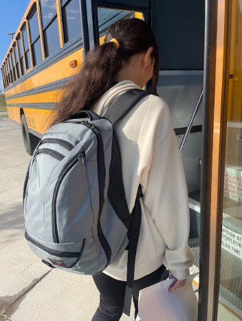 Next Stop! 8th grader, Dalys Maya gets on the bus. Maya boards onto bus 50 after a long day of school. My favorite part of the bus is getting to listen to music on the way home, Maya said.