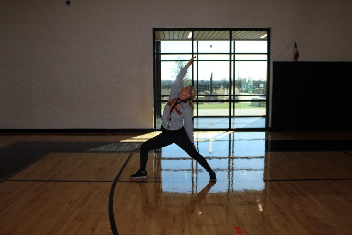 Stretch it out! Coach cannon hits a yoga pose to demonstrate the easy form of exercise. 