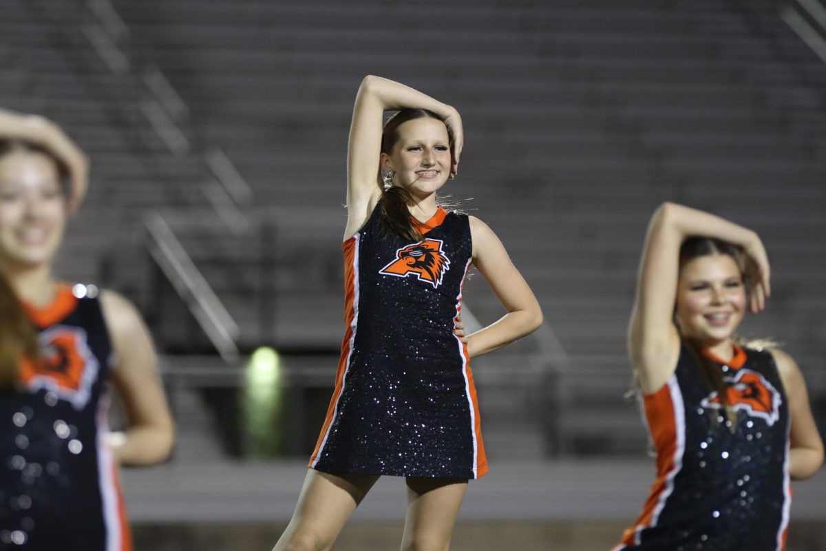Madison Bugrwald hits a pose for the Aledo football game at the end of there half time dance!