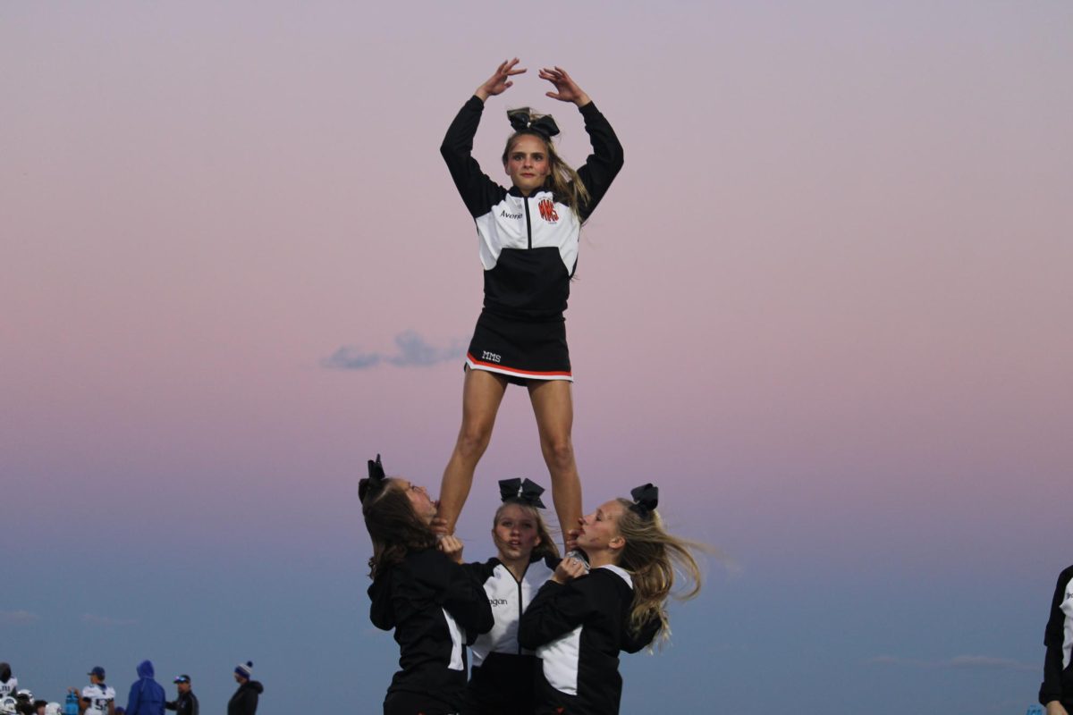 8th grader Carlyle Palmer bases 8th grader Averie Long for their Halloween halftime at the last football game. Carlyle said, "It was hard but fun, and overall I enjoyed basing Averie." 
