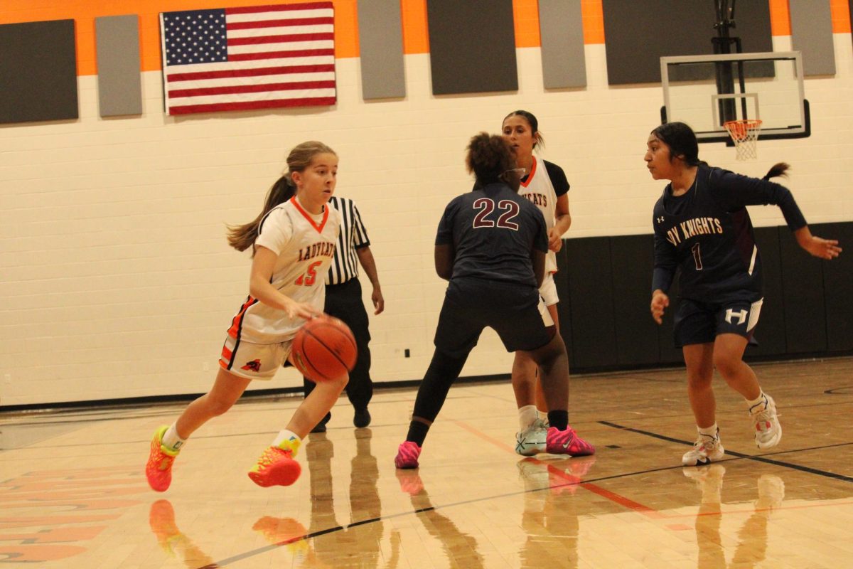 I'm Open! A-Team player, Charlee Southard, dribbles down the court, trying to get the ball away from the other team's players. She knows that she has to score or pass the ball to help win the game. 
