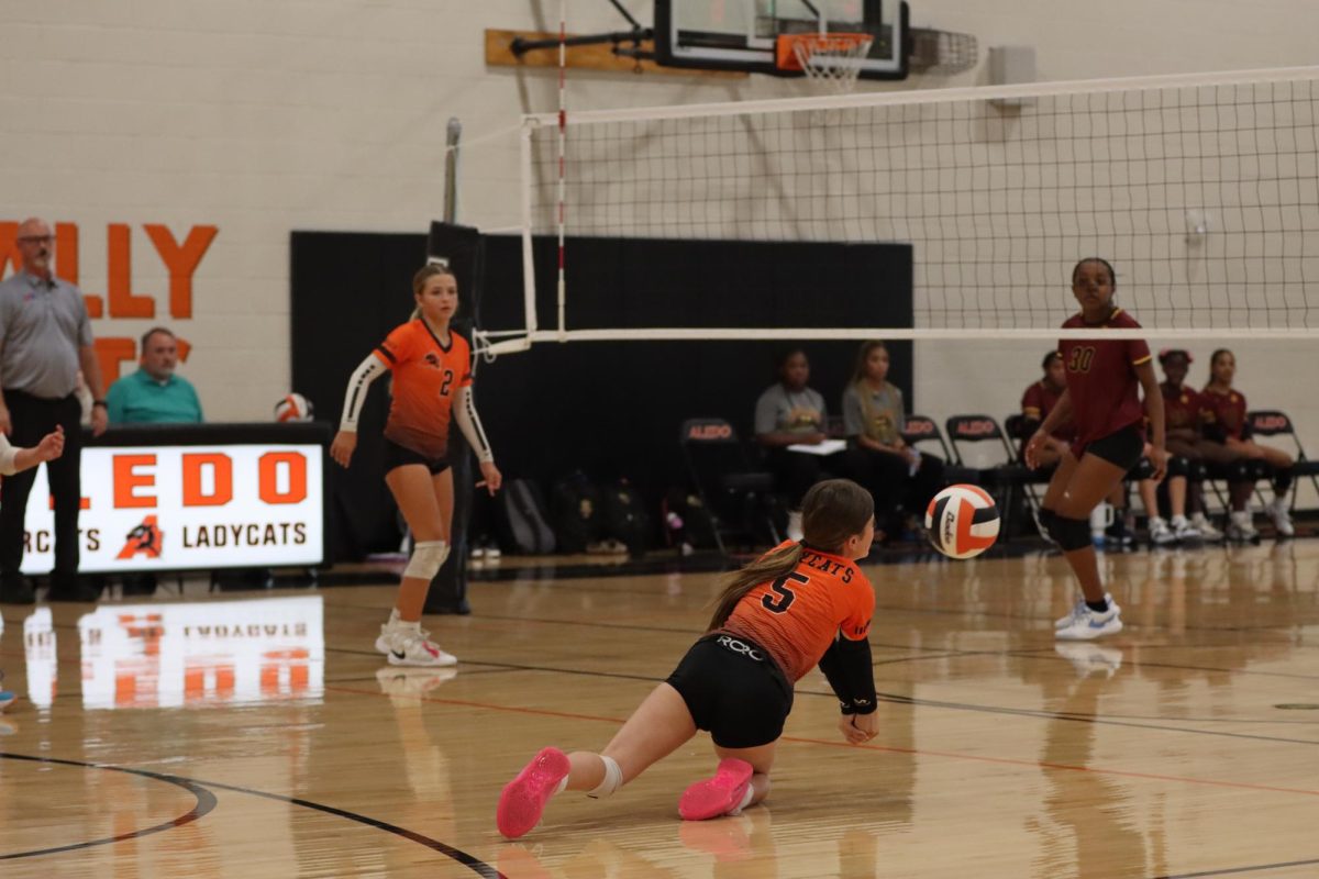 In the final points of the second set against  Mansfield McKinzey Middle, the other teams Middle tips the ball into the middle of the court. Hannah Botts does a dolphin dive to save the ball from hitting the floor.