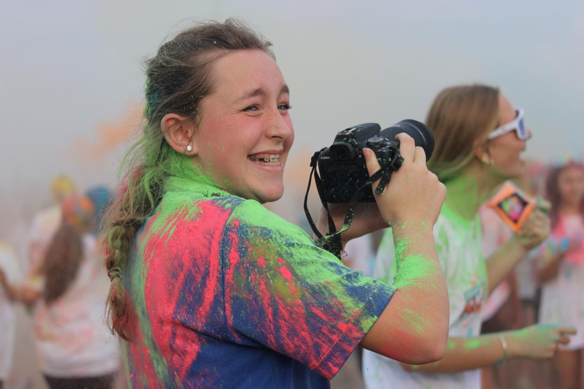 Capturing the moment, 8th grader Hallie Menard, captures the exact moment her friend Kate Rogers gets hit with the color powder. "I was laughing at her, I was worried about the camera but she cleaned up well!".